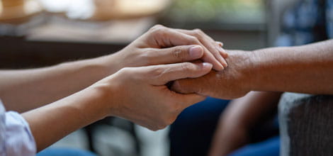 Doctor holding patient's hand